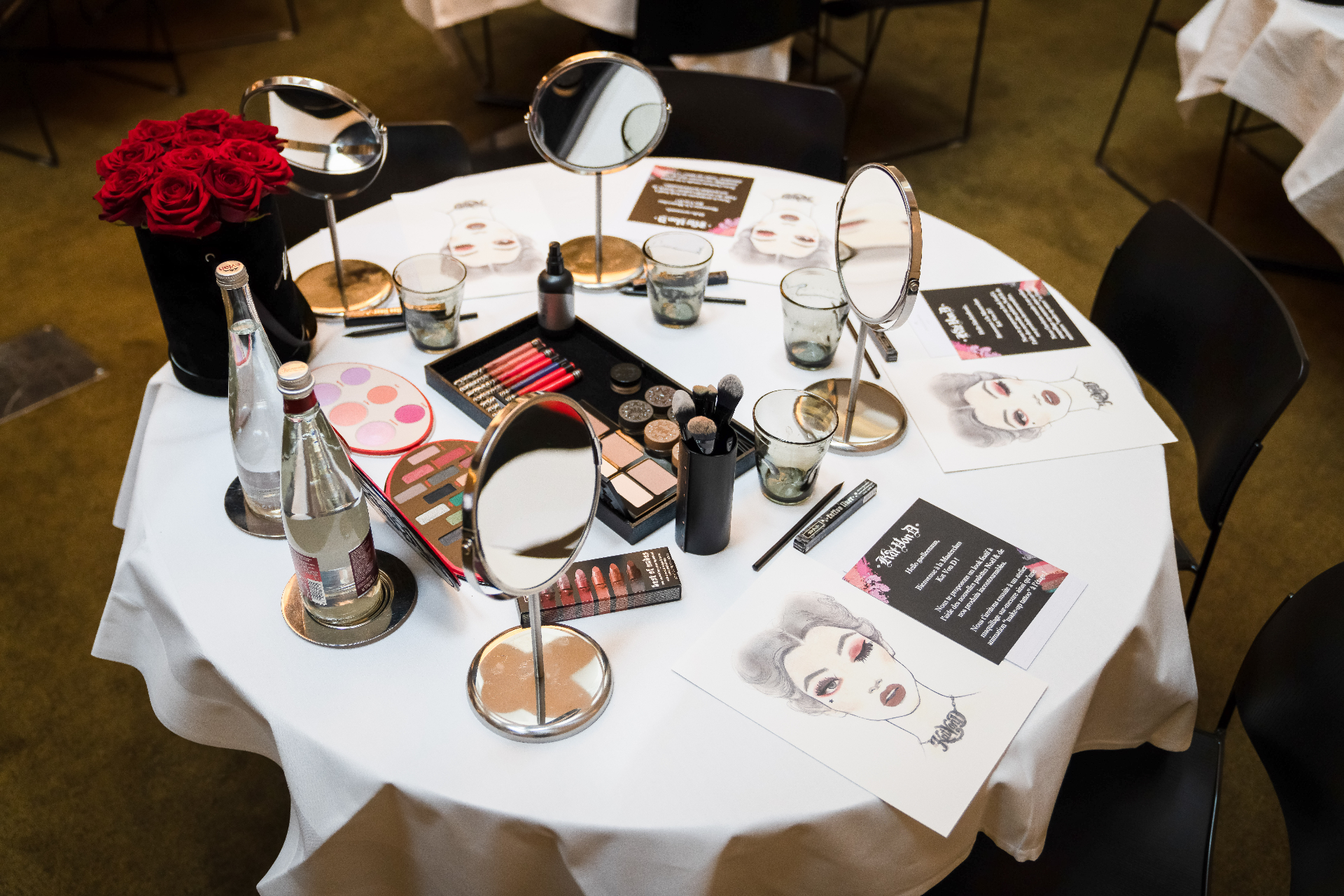 Makeup table set up for a beauty event, mirrors and products